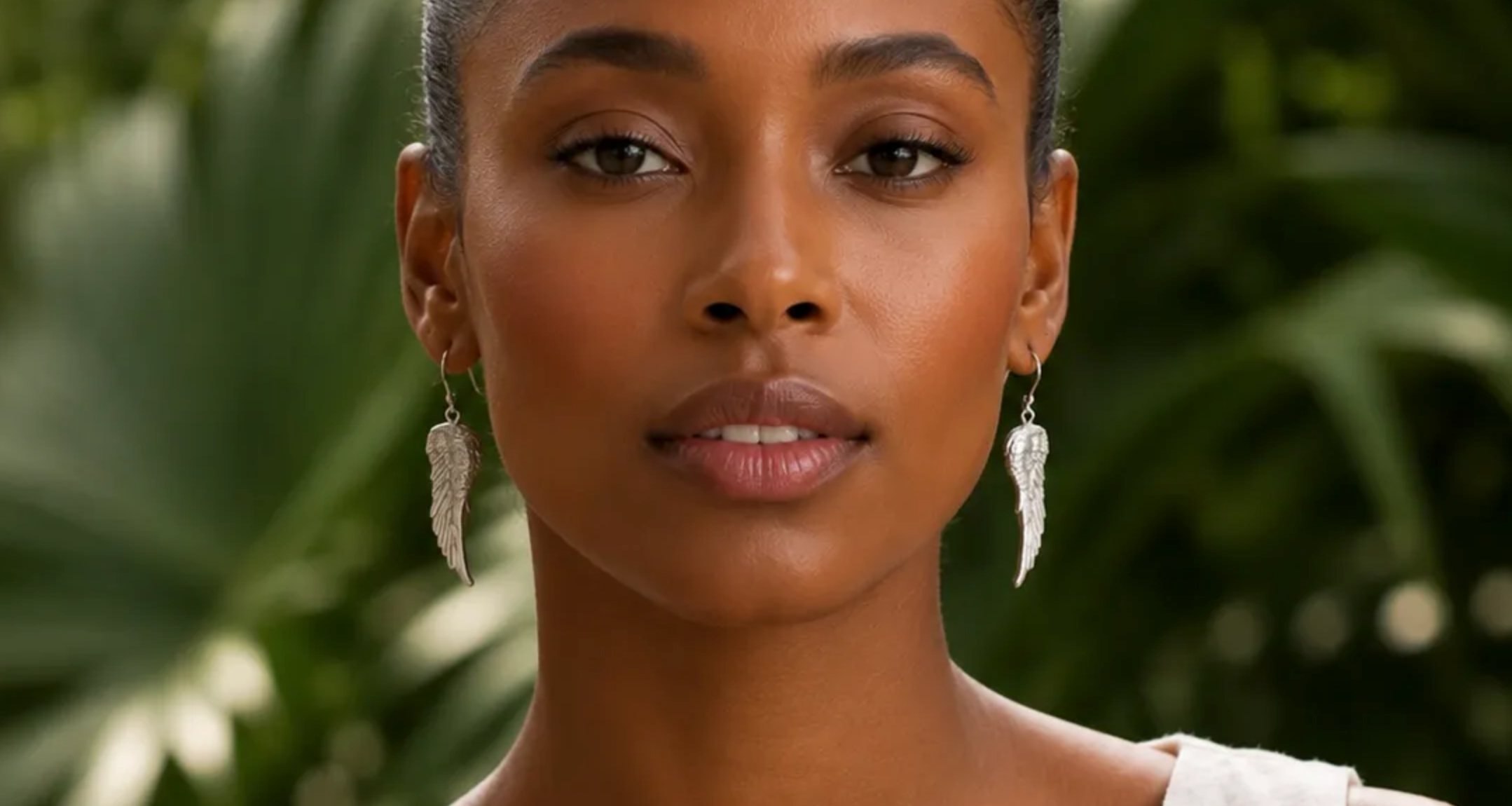 Woman wearing silver angel wing earrings by MariaRyan Jewelry