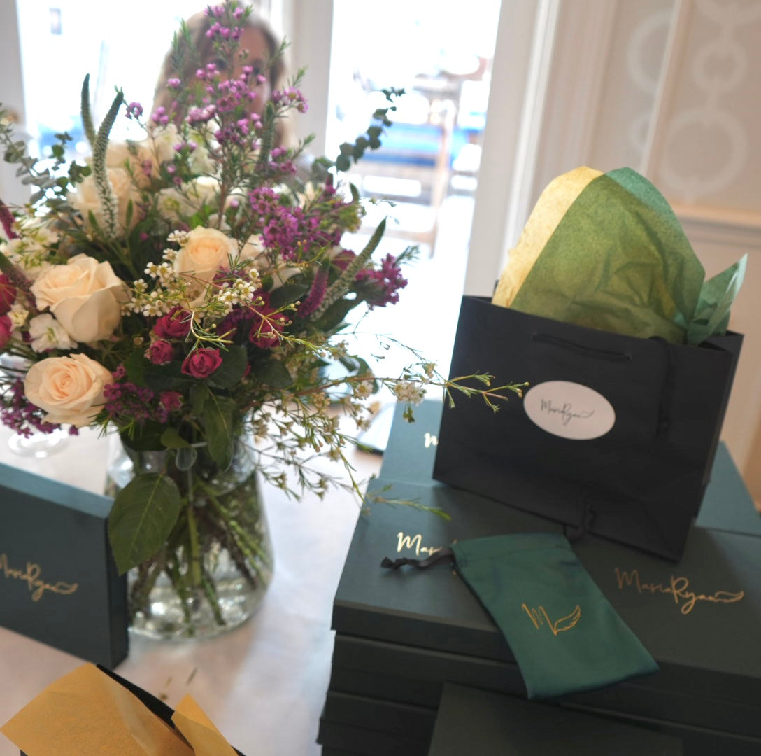 Trunk show table display of MariaRyan Jewelry packaging